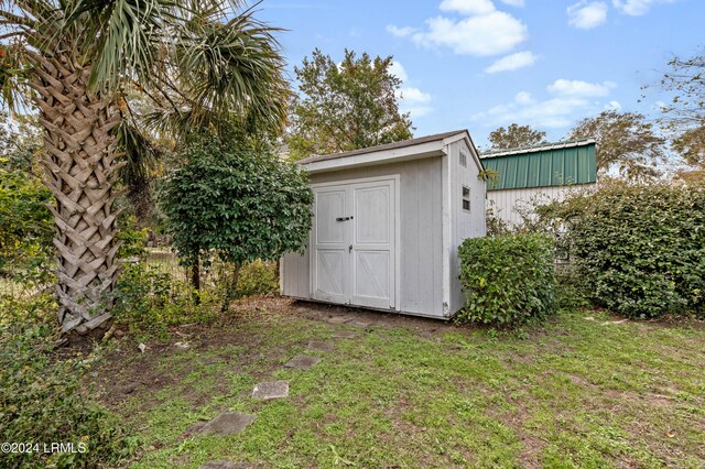 view of outdoor structure featuring a lawn