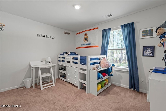 carpeted bedroom with visible vents and baseboards