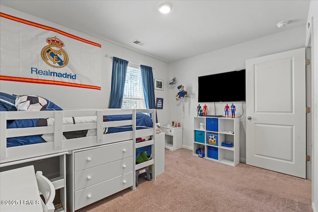 carpeted bedroom featuring visible vents and baseboards