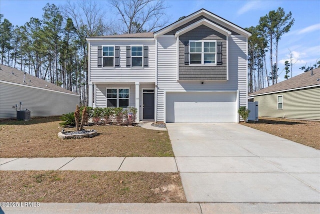 view of front of home with cooling unit, an attached garage, and concrete driveway