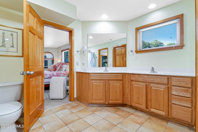 bathroom with tile patterned floors, toilet, and vanity