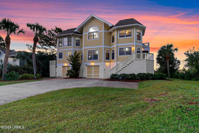 view of front of house featuring a garage and a yard