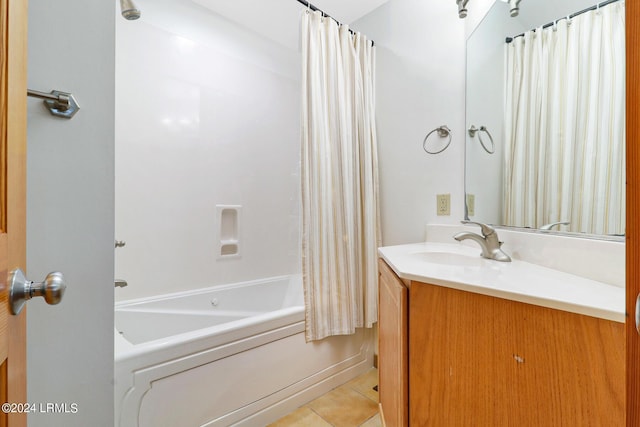 bathroom featuring tile patterned flooring, vanity, and shower / bath combo with shower curtain