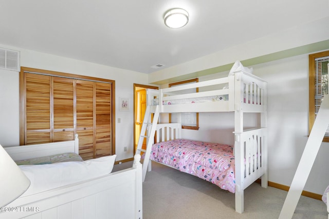 carpeted bedroom with a closet