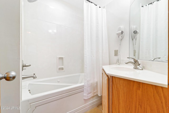 bathroom featuring vanity and shower / bathtub combination with curtain