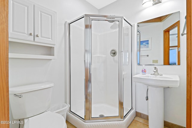 bathroom with a shower with door and toilet