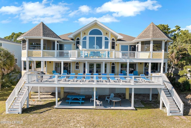 back of house with a yard and a patio