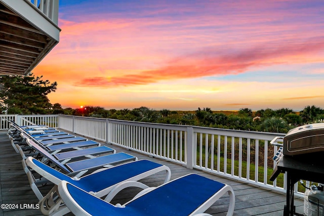 deck at dusk with grilling area