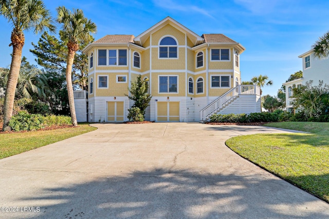 view of front of home featuring a garage and a front lawn