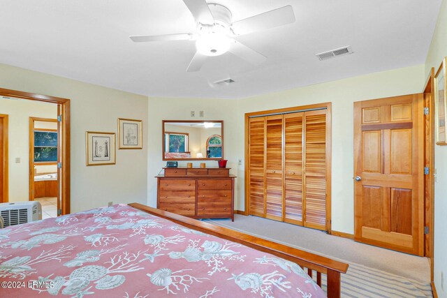 bedroom with ceiling fan, carpet, and a closet