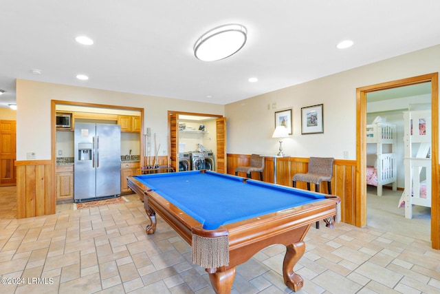 game room featuring pool table, wooden walls, and washing machine and clothes dryer