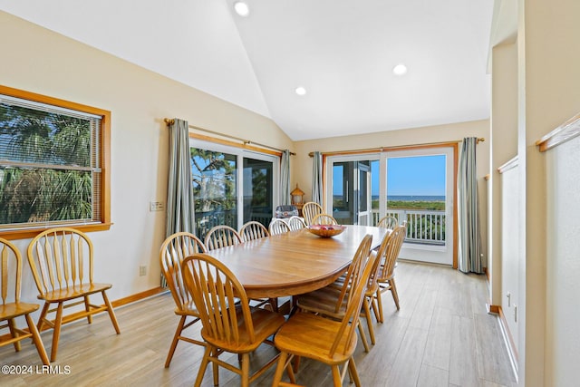 dining area with lofted ceiling and light hardwood / wood-style floors