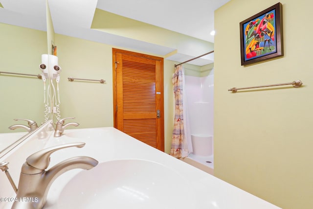 bathroom with curtained shower and sink