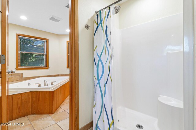 bathroom featuring tile patterned floors and independent shower and bath