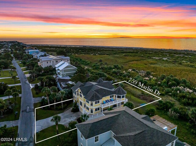 aerial view at dusk with a water view