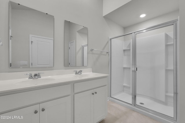 bathroom with vanity and a shower with shower door