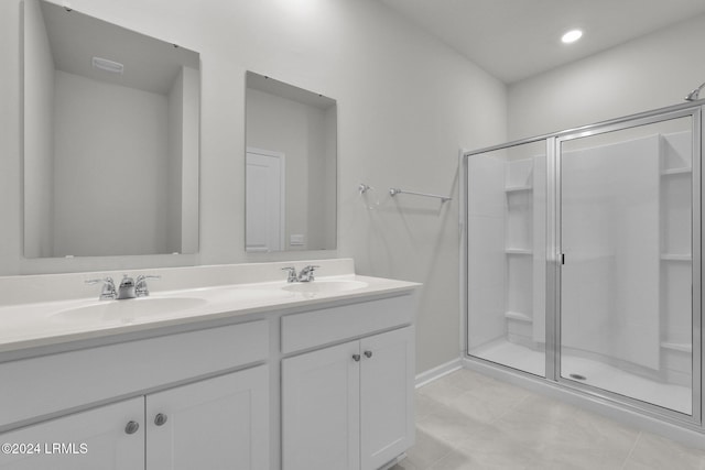 bathroom with vanity, tile patterned flooring, and a shower with door