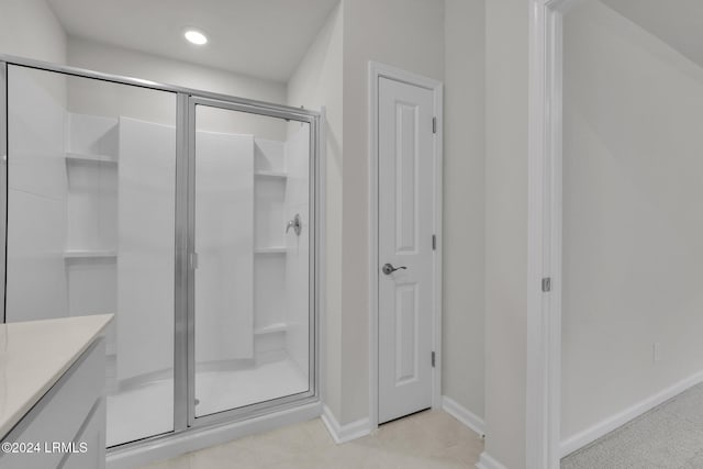 bathroom featuring vanity and a shower with shower door