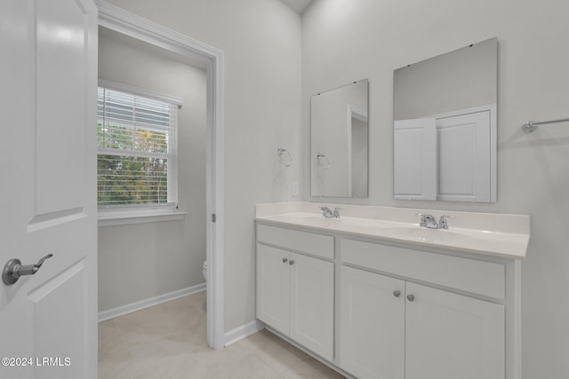 bathroom featuring vanity, toilet, and tile patterned flooring