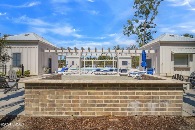 view of pool featuring a patio area and an outdoor bar