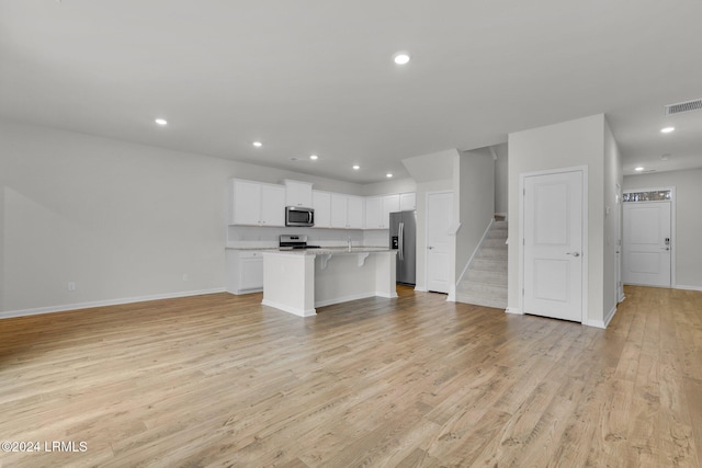 unfurnished living room featuring light wood-type flooring