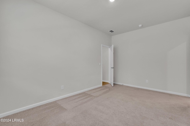 unfurnished room with light colored carpet