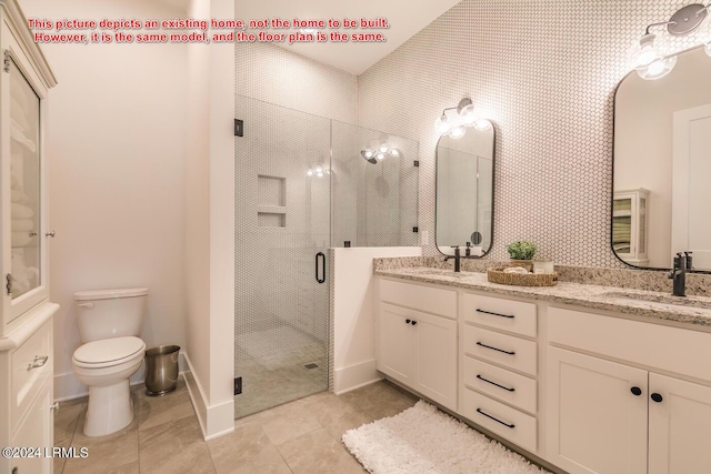 bathroom with vanity, tile patterned flooring, a shower with door, and toilet