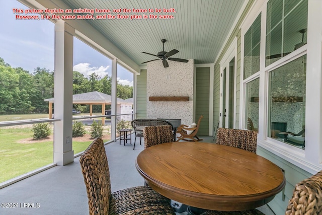 sunroom featuring ceiling fan