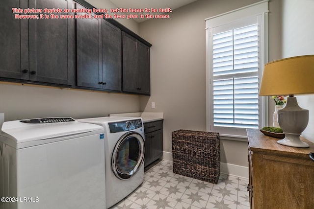 laundry room with separate washer and dryer and cabinets