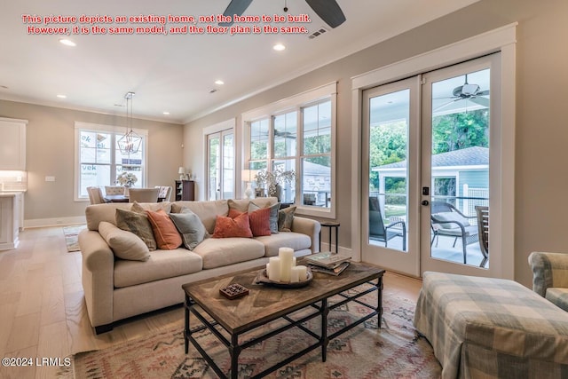 living room featuring crown molding, ceiling fan, and light hardwood / wood-style flooring