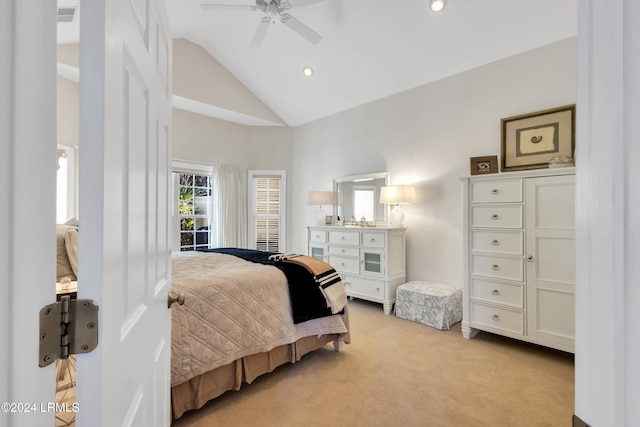 bedroom with ceiling fan, high vaulted ceiling, and light carpet