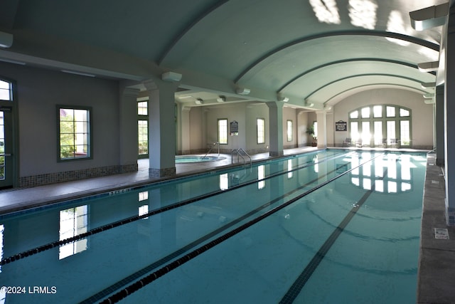 view of swimming pool with ornate columns