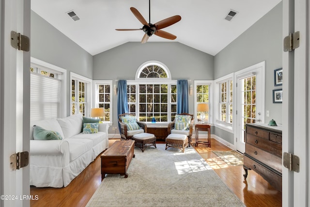 living room featuring lofted ceiling, a wealth of natural light, ceiling fan, and light hardwood / wood-style flooring