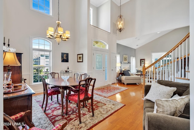 dining room with a high ceiling, hardwood / wood-style floors, and a notable chandelier