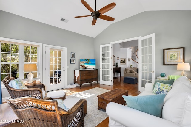 living room with french doors, ceiling fan, wood-type flooring, and vaulted ceiling