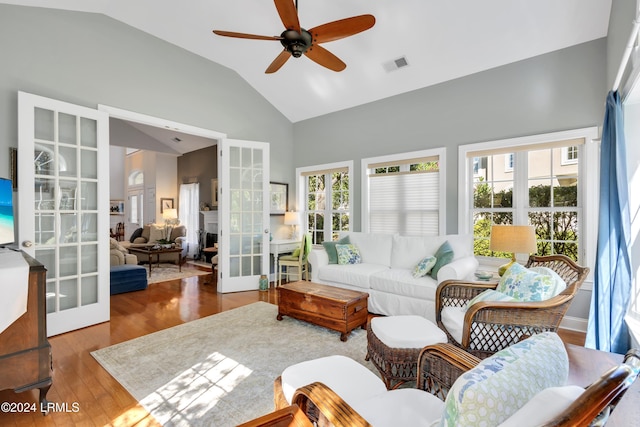 living room with french doors, ceiling fan, dark hardwood / wood-style floors, and vaulted ceiling