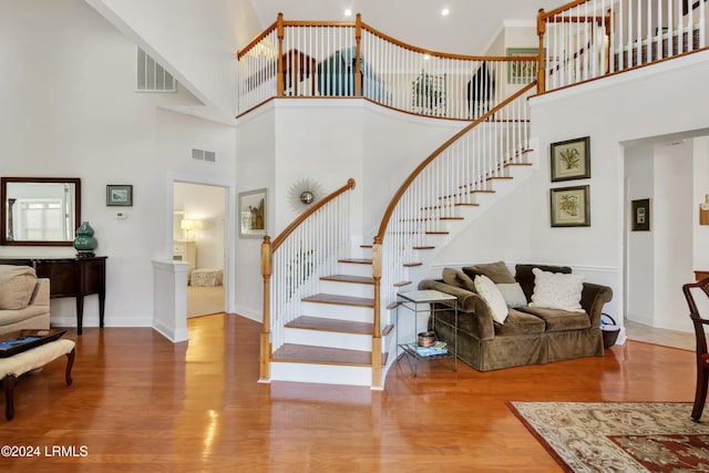 interior space with a high ceiling and hardwood / wood-style floors