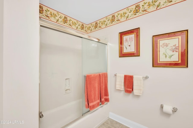 bathroom with shower / bath combination with glass door