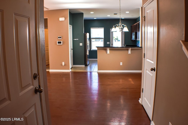 48 Pennyroyal Way, Beaufort, SC 29906 - kitchen with a chandelier, dark countertops, appliances with stainless steel finishes, a peninsula, and a kitchen bar