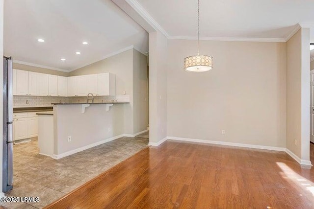 1 Wateree Ct, Beaufort, SC 29902 - unfurnished dining area featuring crown molding, light wood-type flooring, and recessed lighting