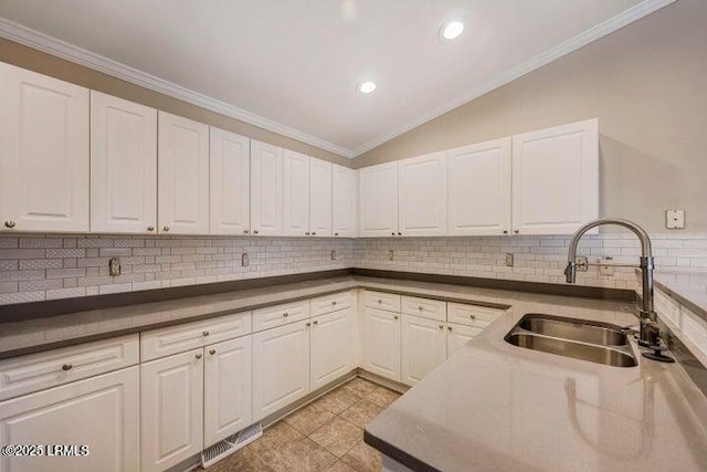 1 Wateree Ct, Beaufort, SC 29902 - kitchen featuring white cabinets, lofted ceiling, crown molding, decorative backsplash, and recessed lighting