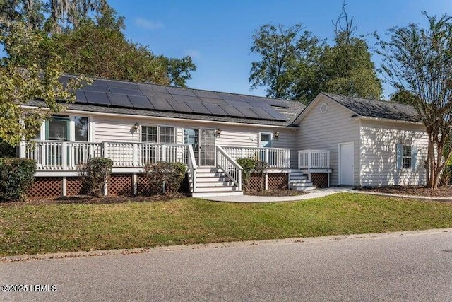 1 Wateree Ct, Beaufort, SC 29902 - view of front facade featuring solar panels, a front yard, and a wooden deck