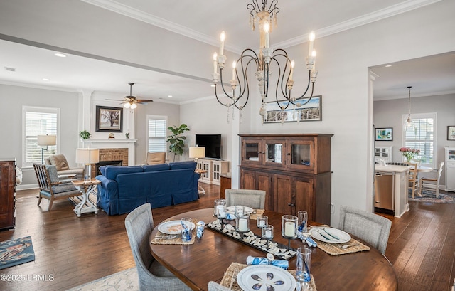 dining room with a wealth of natural light, a fireplace, and dark hardwood / wood-style floors