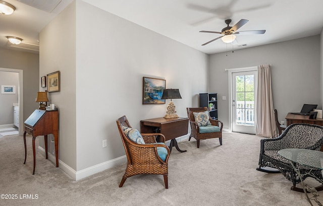 living area featuring light colored carpet and ceiling fan