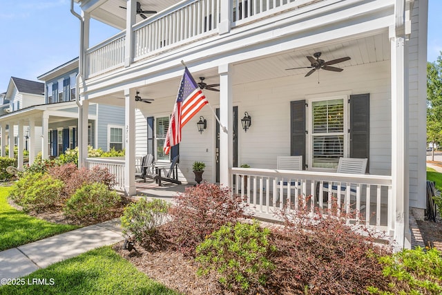 view of front of home with ceiling fan, a balcony, and covered porch