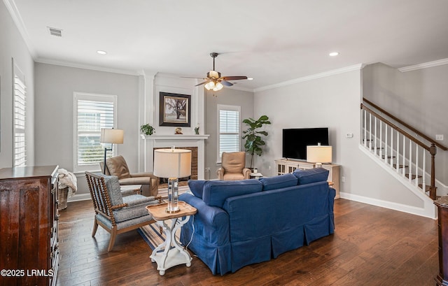 living room with dark hardwood / wood-style flooring, ornamental molding, and ceiling fan