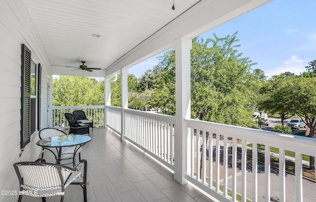 balcony with ceiling fan and a porch