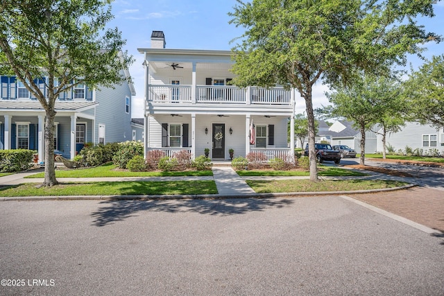 view of front of property featuring ceiling fan, a porch, and a balcony