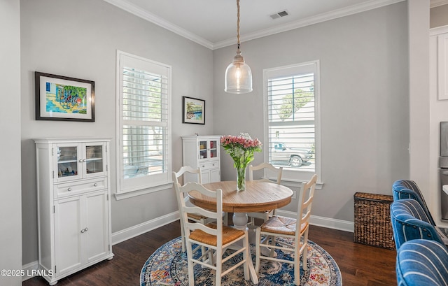 dining space with crown molding and dark hardwood / wood-style floors