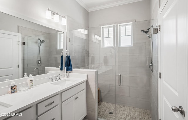 bathroom featuring a shower with door, crown molding, and vanity